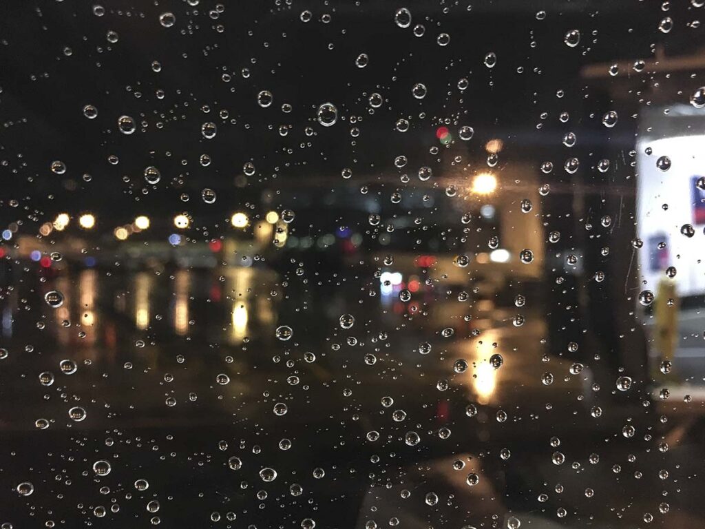 Pushing off the gate in the rain at night at the Seattle Tacoma airport