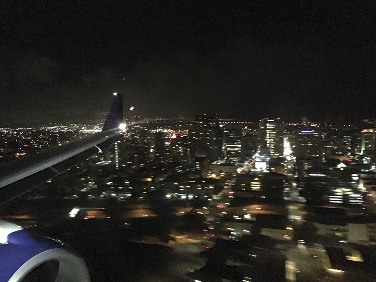 Approaching the San Diego airport and a delta connection Embraer 175 at night