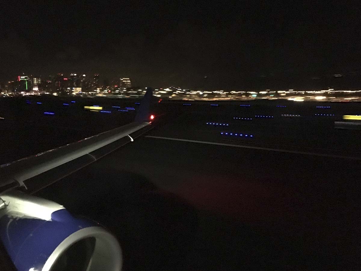 Arriving at the San Diego international airport at night in a delta connection Embraer 175