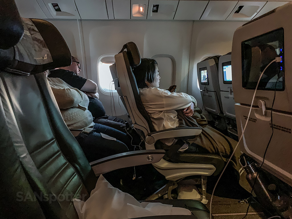 Passengers sleeping in Icelandair 767-300 economy 