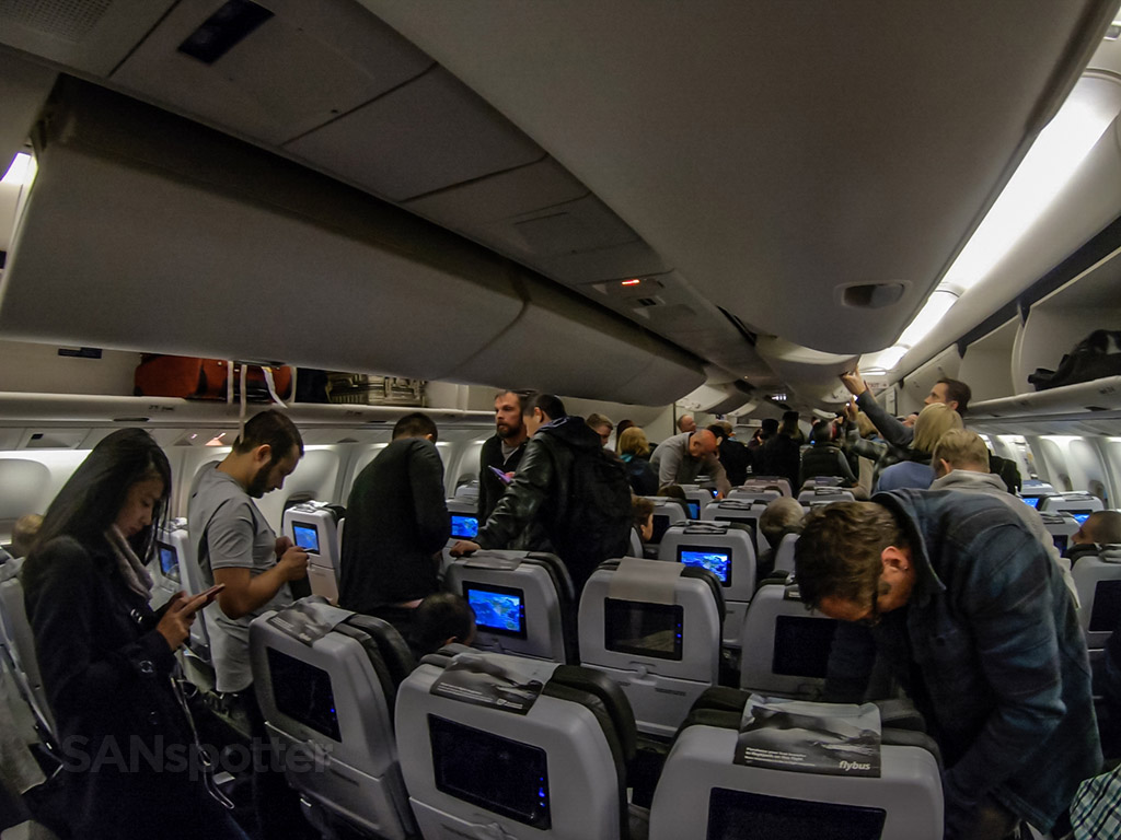 Passengers waiting to deplane Icelandair 767-300 economy 2018