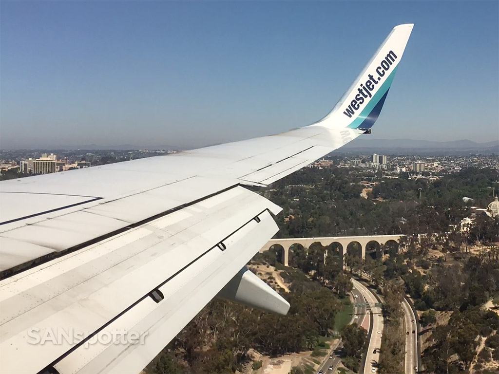 Westjet 737-700 flying over Balboa Park on approach into San Diego airport