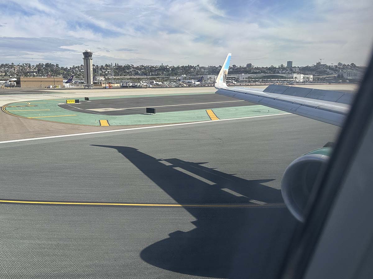 Frontier Airlines A321 engine and wing view while landing on runway 27 San Diego airport