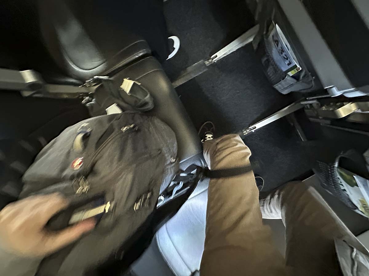Retrieving my carry-on bag from under the seat in front of me Frontier Airlines A321 UpFront Plus